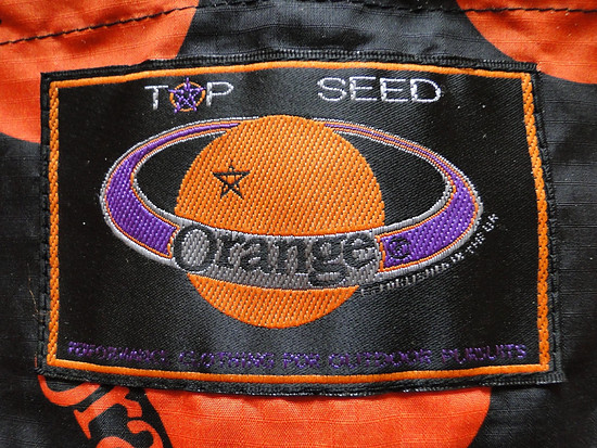 Orange Cycles Regenjacke Logo Sticker Kragen Hinten